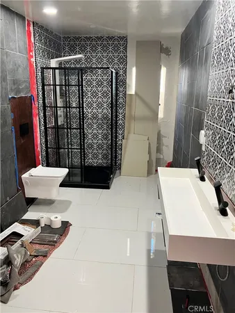 a bathroom with a sink toilet and shower