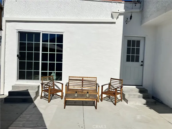a building outdoor space with patio furniture and potted plants