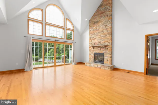 a view of an room with wooden floor and a window