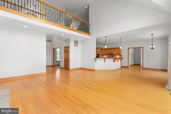 a view of an empty room with a fireplace and a window