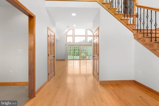 a view of an empty room with glass door and windows