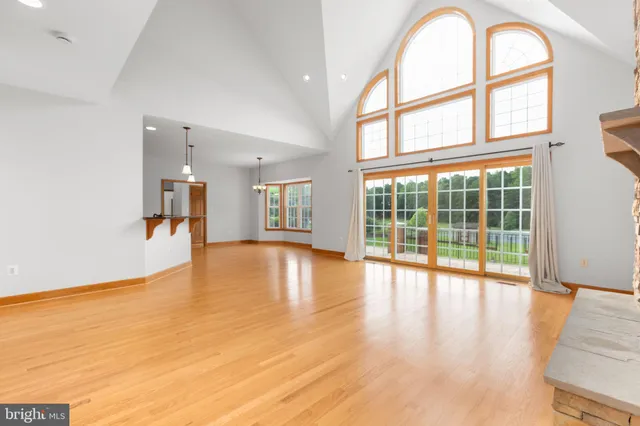 a kitchen with stainless steel appliances granite countertop a refrigerator a stove and a sink with wooden cabinets