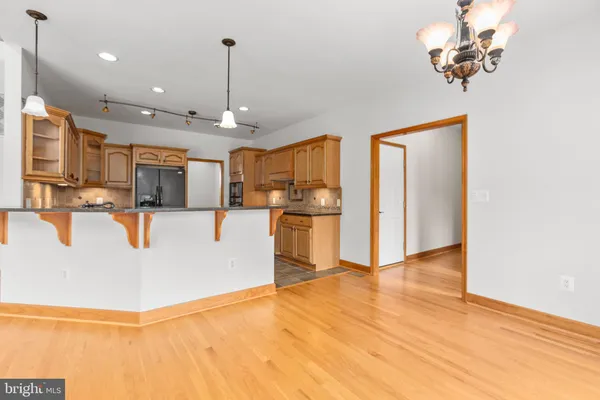 an empty room with windows and ceiling fan