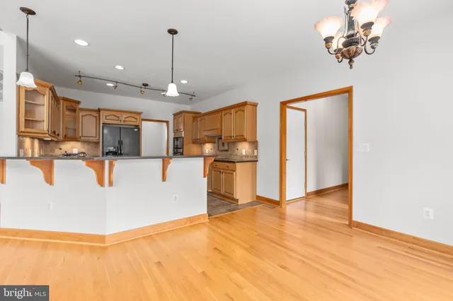 an empty room with windows and ceiling fan