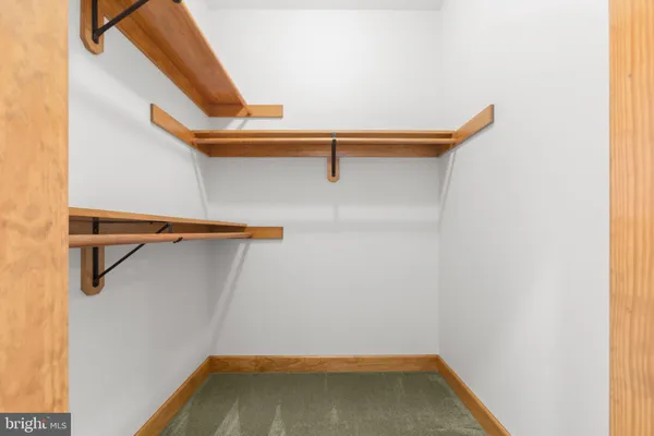 a view of a hallway with wooden walls and stairs