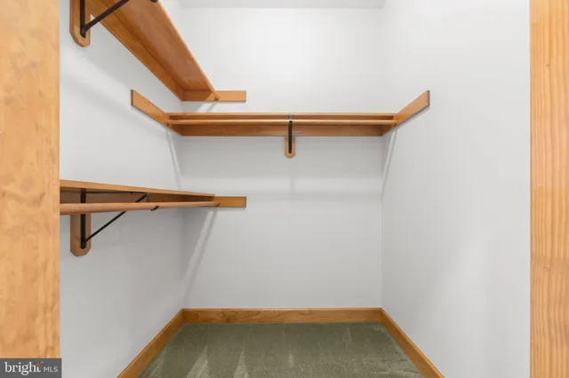 a view of a hallway with wooden walls and stairs