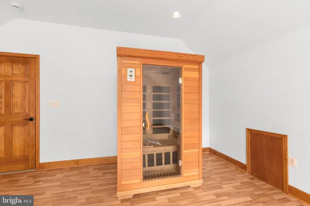 an aerial view of a house a yard and mountain view in back