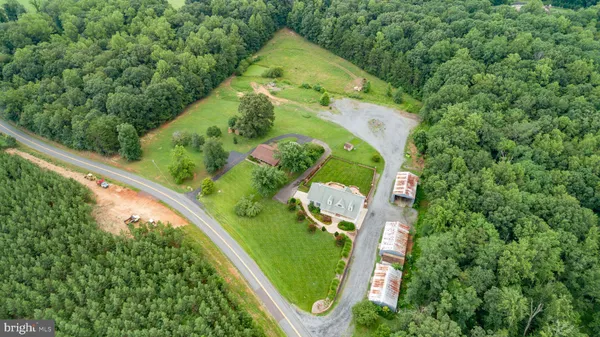 an aerial view of a house with a garden and swimming pool