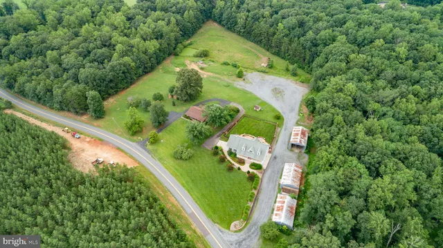 an aerial view of a house with a garden and swimming pool