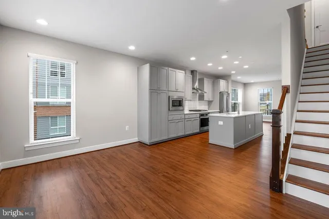 a view of kitchen with wooden floor and electronic appliances
