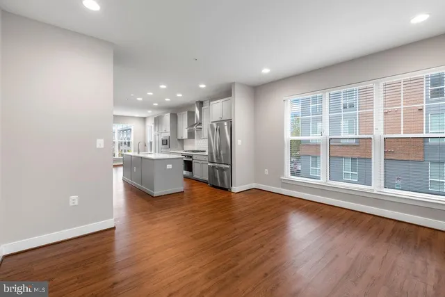 a view of kitchen with wooden floor and electronic appliances