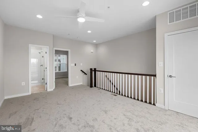 an empty room with closet and a bathroom