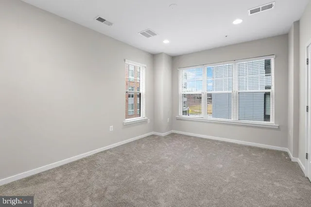 a white toilet sitting next to a window