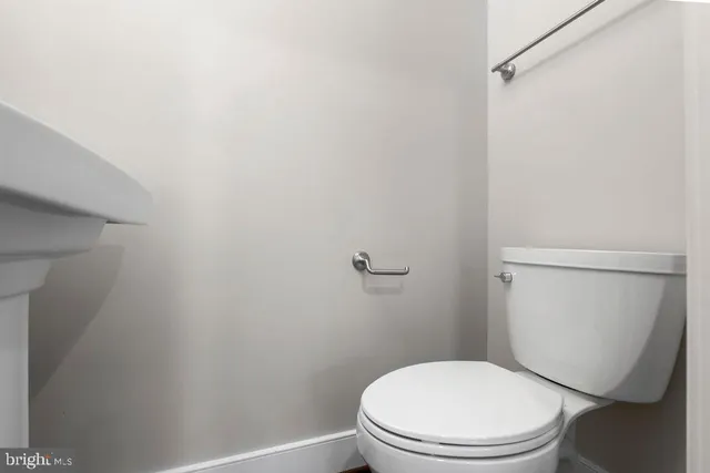 a white toilet sitting next to a shower