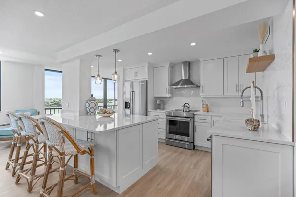 a kitchen with kitchen island granite countertop lots of counter top space and stainless steel appliances
