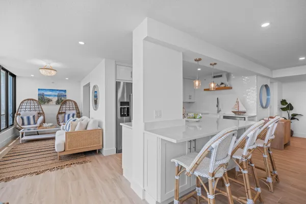 a view of a dining room with furniture and a chandelier