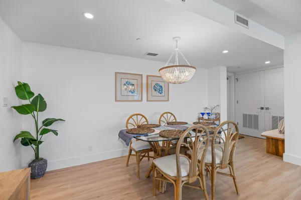 a view of a dining room with furniture wooden floor and chandelier
