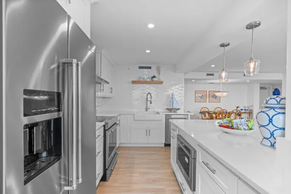 a kitchen with lot of cabinets and appliances