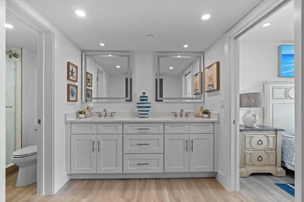 a bathroom with a double vanity sink a mirror and a