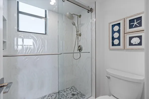 a living room with furniture a mirror and a window