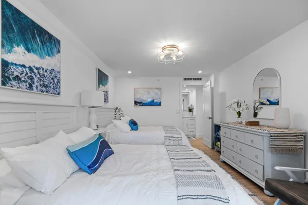 a bedroom with a bed and a painting on the wall