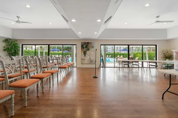 a kitchen with a sink dishwasher and white cabinets with wooden floor