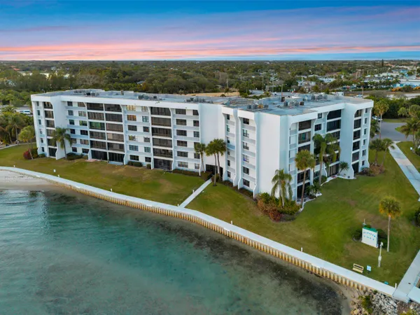 an aerial view of residential houses with outdoor space and river