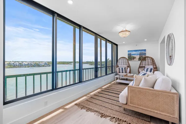 a living room with furniture wooden floor and a large window