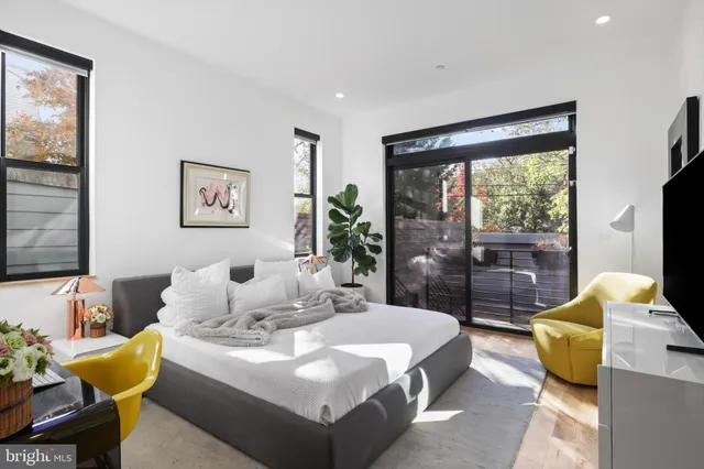 a bedroom with a bed and a flat screen television