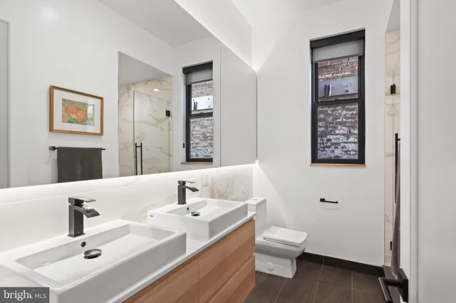 a living room with furniture kitchen view and a large window
