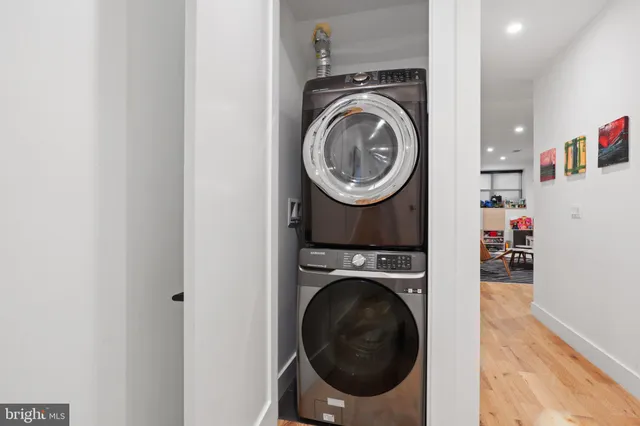 a living room with furniture and painting on the wall