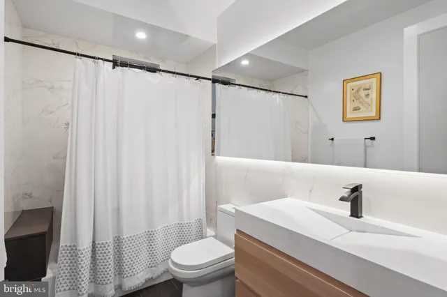 a bedroom with furniture and large window