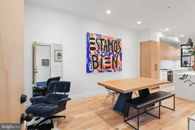 a living room with furniture and paintings on the wall