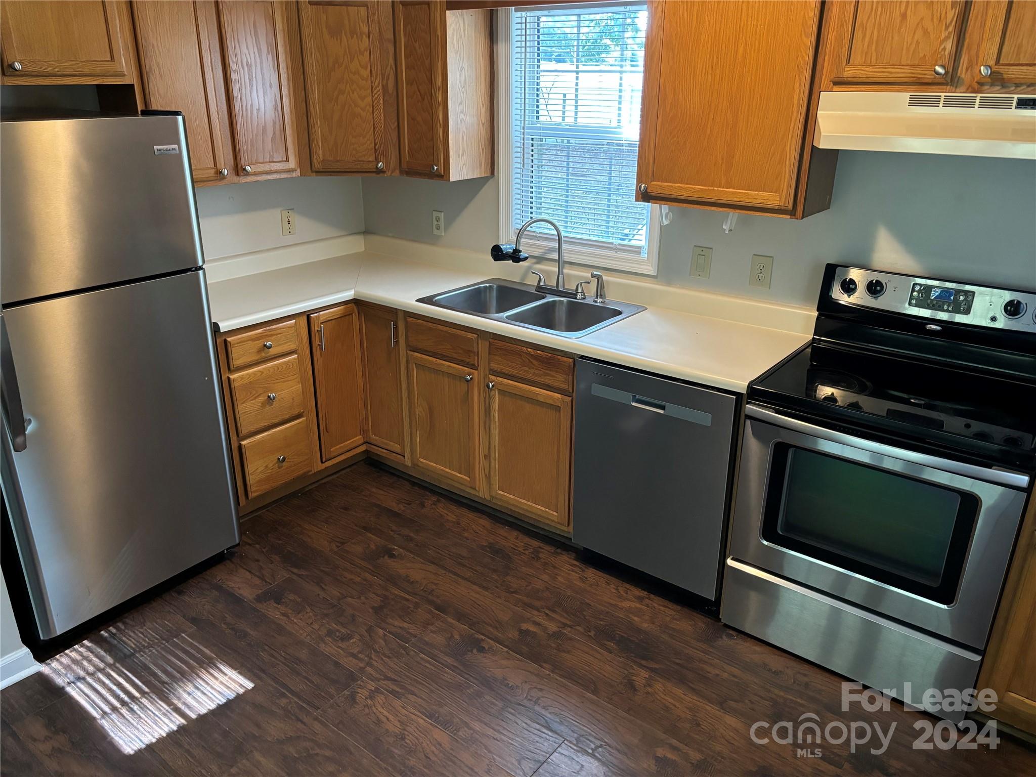 276 Isle Of Pines Road, Unit B Mooresville, NC 28117 - Photo 4 of 8 a kitchen with granite countertop a refrigerator stove and sink