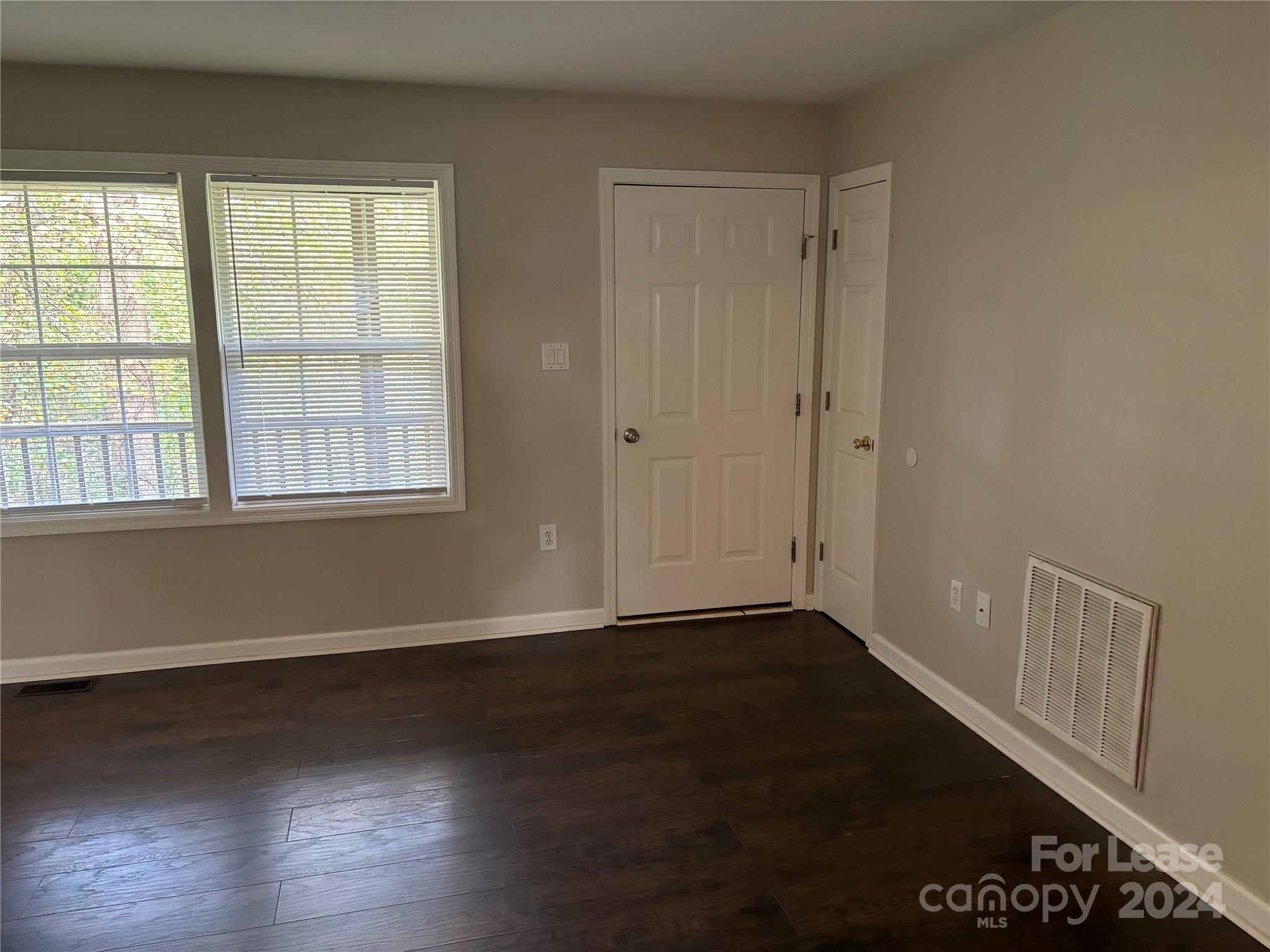276 Isle Of Pines Road, Unit B Mooresville, NC 28117 - Photo 6 of 8 a view of an empty room with wooden floor and a window