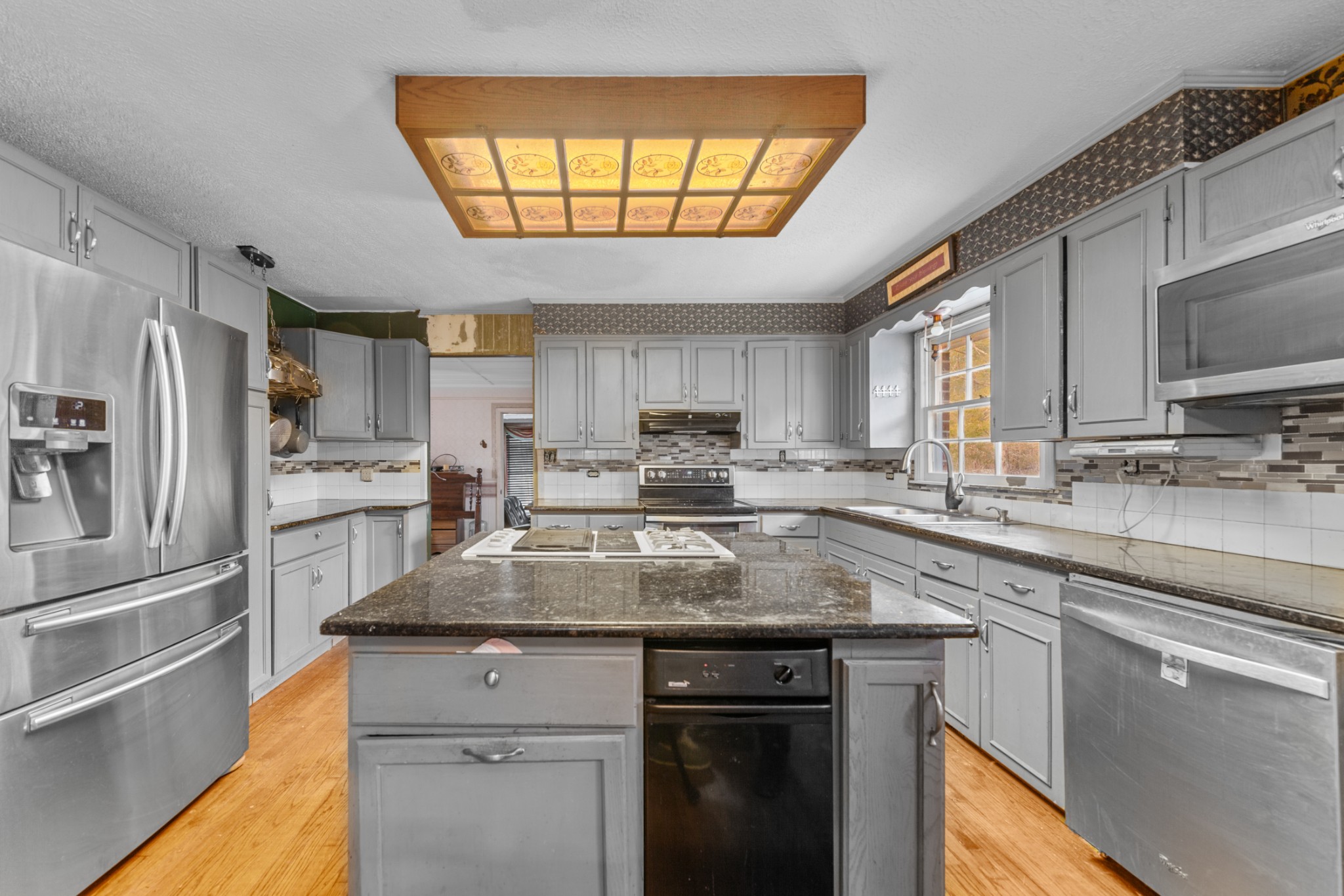 1555 Amos Hamlett Road Pulaski, TN 38478 - Photo 40 of 80 a kitchen with stainless steel appliances granite countertop a sink a stove a refrigerator cabinets and a window