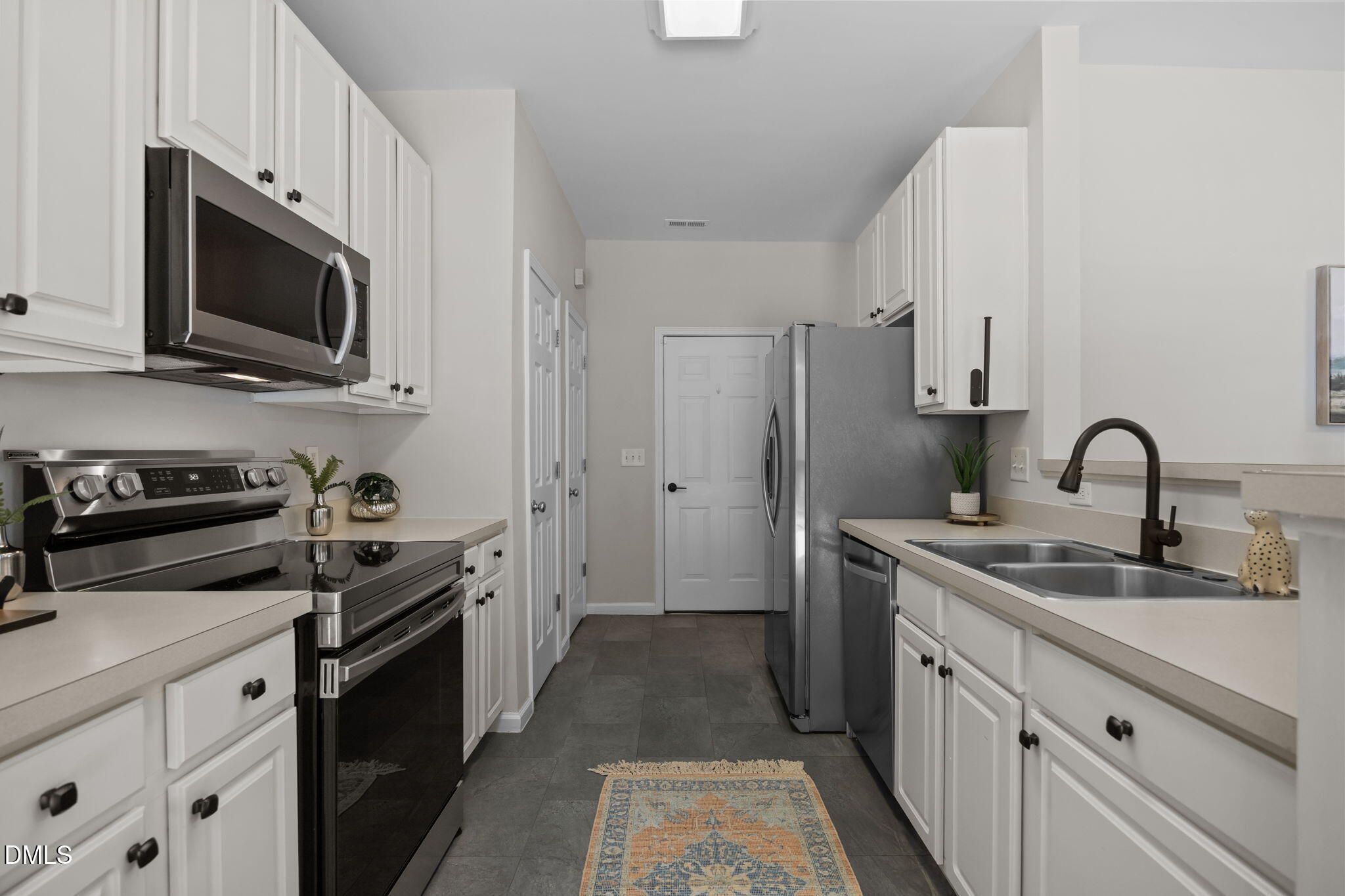 1003 Red Hat Lane Durham, NC 27713 - Photo 27 of 60 a kitchen with stainless steel appliances granite countertop a stove a sink dishwasher a refrigerator and a microwave