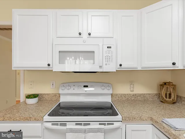 a stove top oven sitting inside of a kitchen