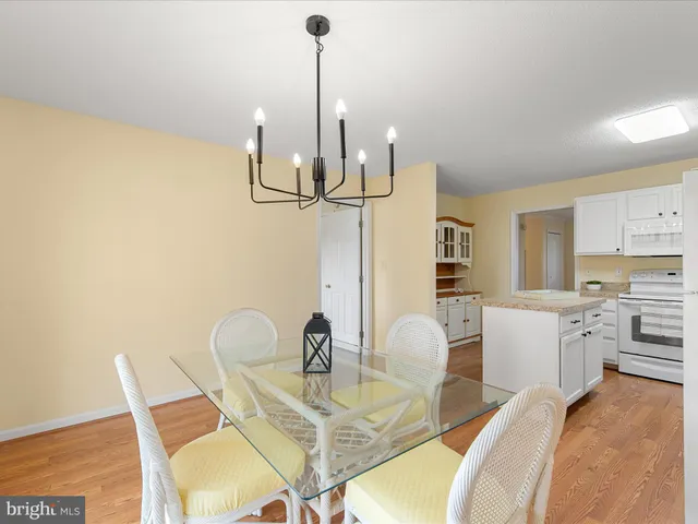 a dining room with furniture and a floor to ceiling window