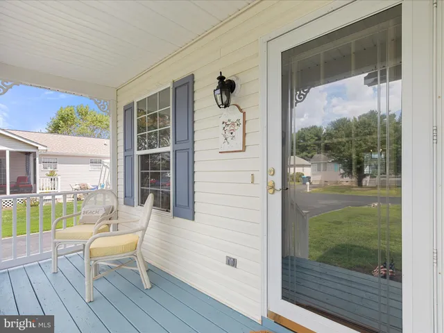 a view of a porch with furniture and garden