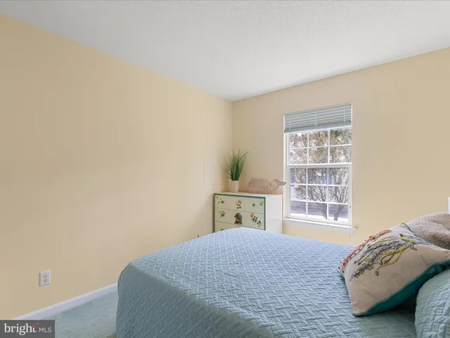 a bedroom with a bed and a night stand