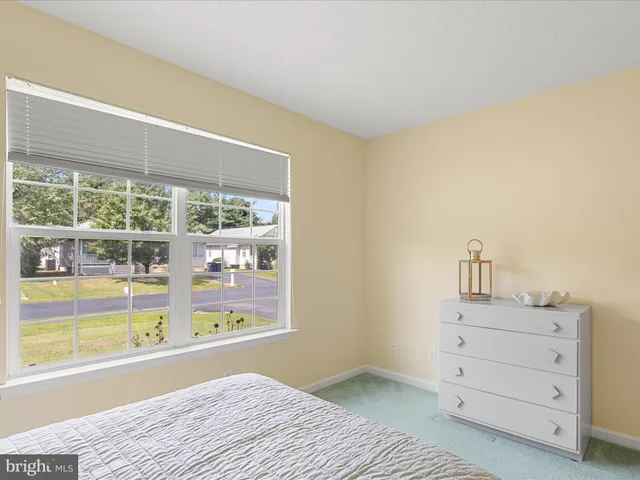 a bedroom with a bed and a night stand