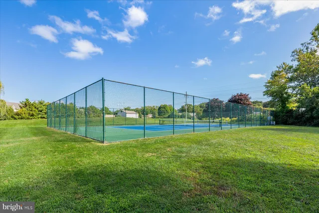 a balcony with wooden fence and trees in the background