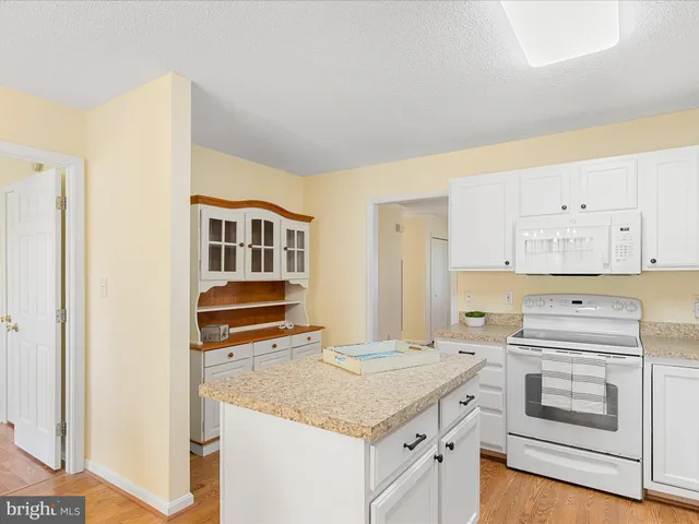 a kitchen with stainless steel appliances granite countertop a stove and a refrigerator