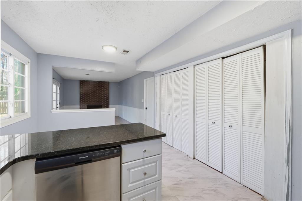 4828 Oak Path Stone Mountain, GA 30088 - Photo 12 of 40 a kitchen with a sink and cabinets