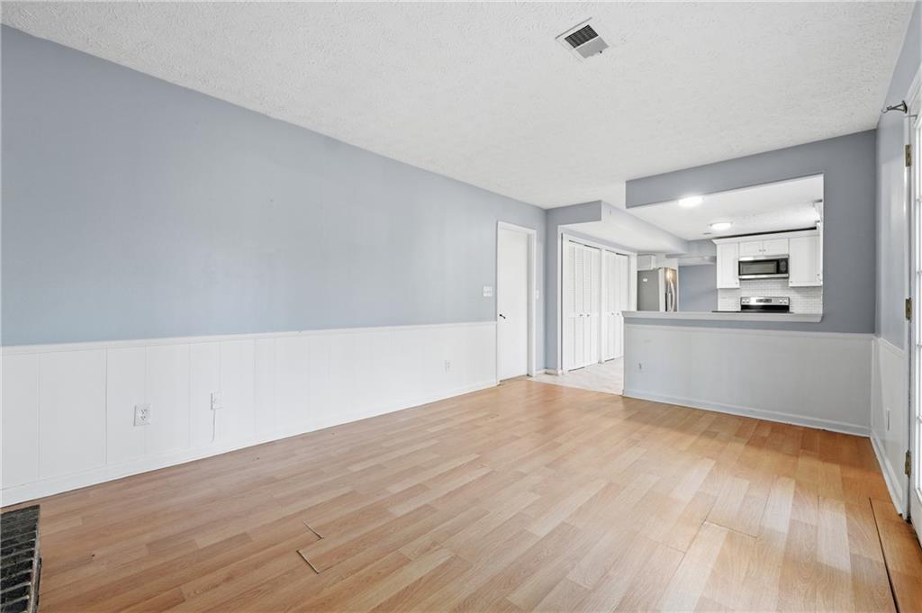 4828 Oak Path Stone Mountain, GA 30088 - Photo 19 of 40 a view of a kitchen with wooden floor and kitchen appliances