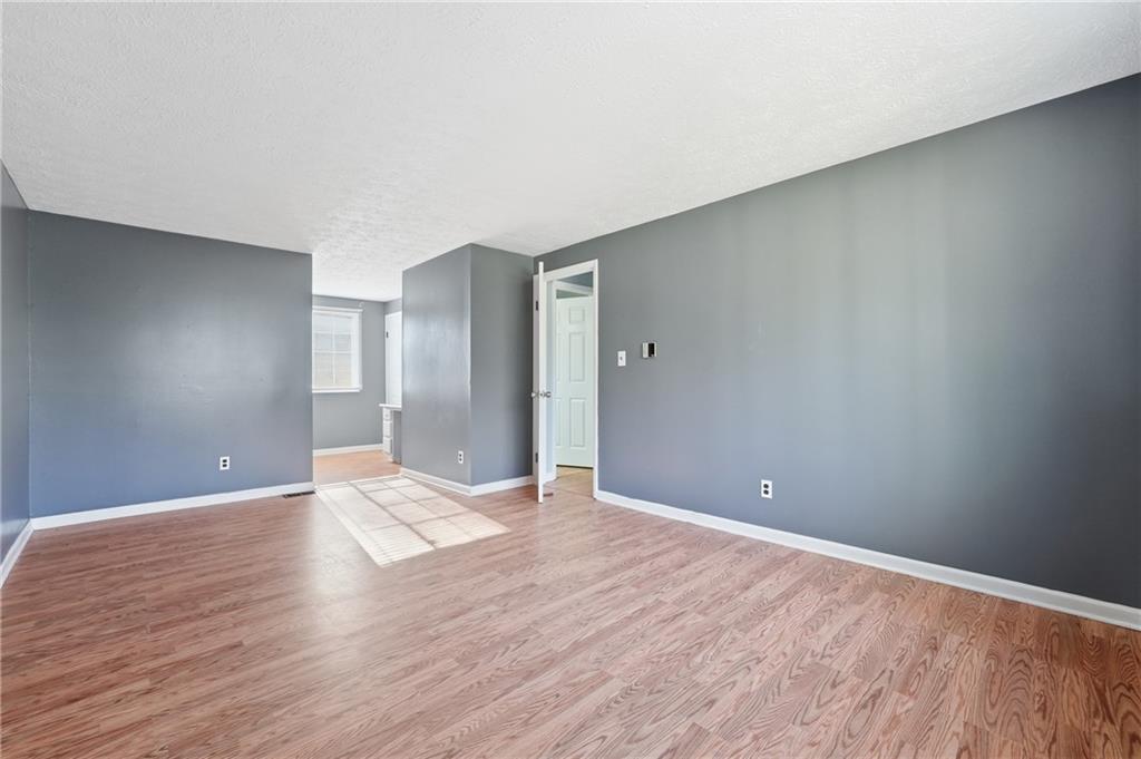 4828 Oak Path Stone Mountain, GA 30088 - Photo 23 of 40 a view of an empty room with wooden floor
