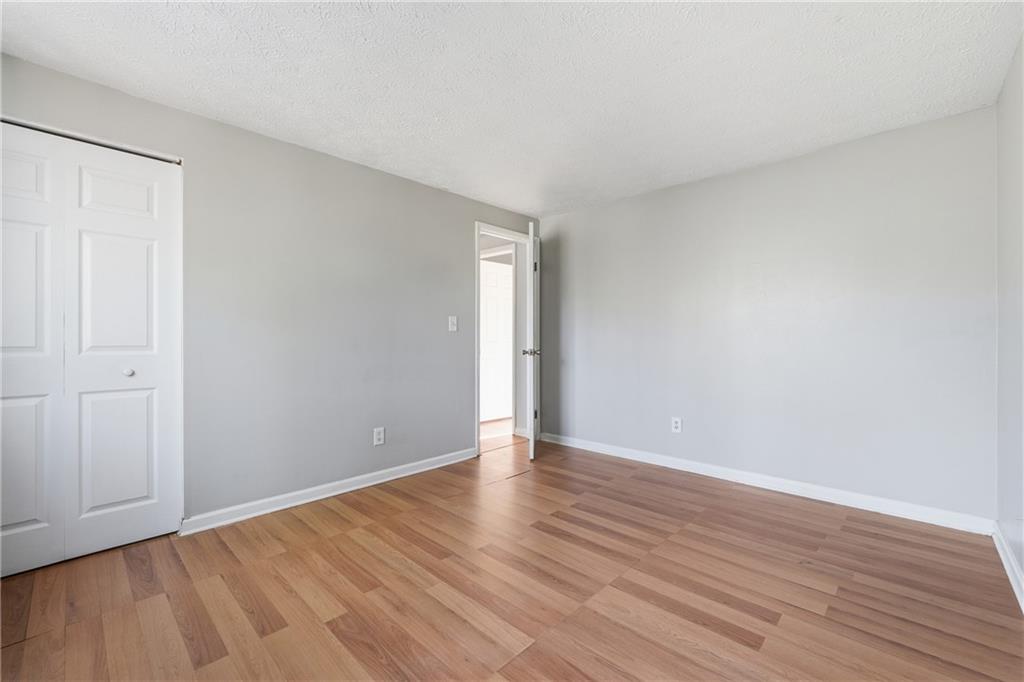 4828 Oak Path Stone Mountain, GA 30088 - Photo 32 of 40 a view of an empty room with wooden floor