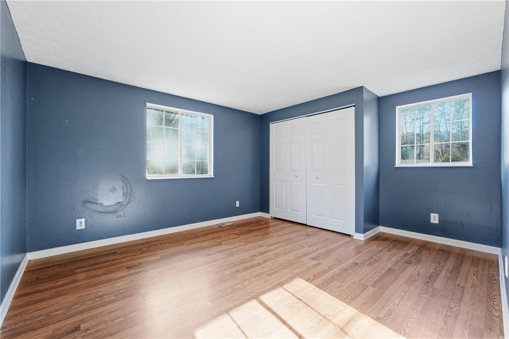 4828 Oak Path Stone Mountain, GA 30088 - Photo 33 of 40 a view of a room with wooden floor and windows