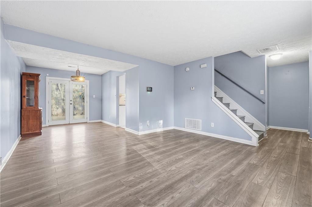 4828 Oak Path Stone Mountain, GA 30088 - Photo 6 of 40 a view of an empty room with wooden floor and a window
